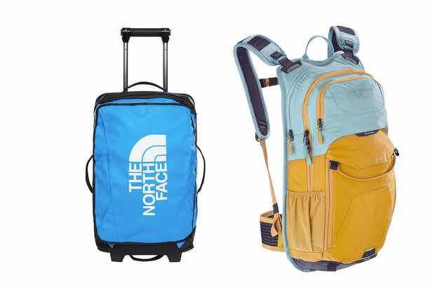 A blue wheeled suitcase and a light blue and orange rucksack on a white background
