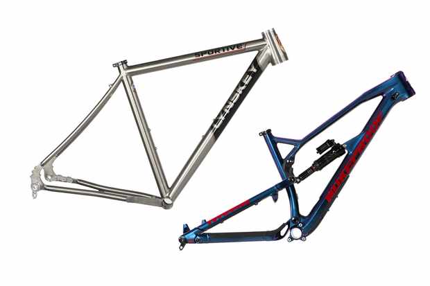 Photograph of a silver road bike frame and blue and red mountain bike frame on a white background